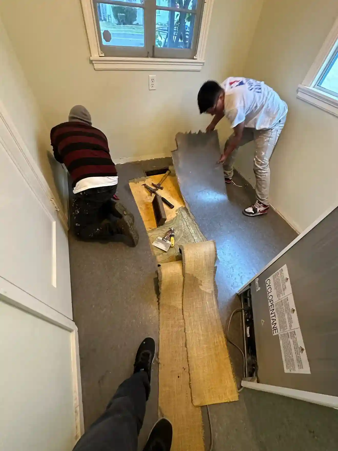Senior wallpaper installer working on a residential project