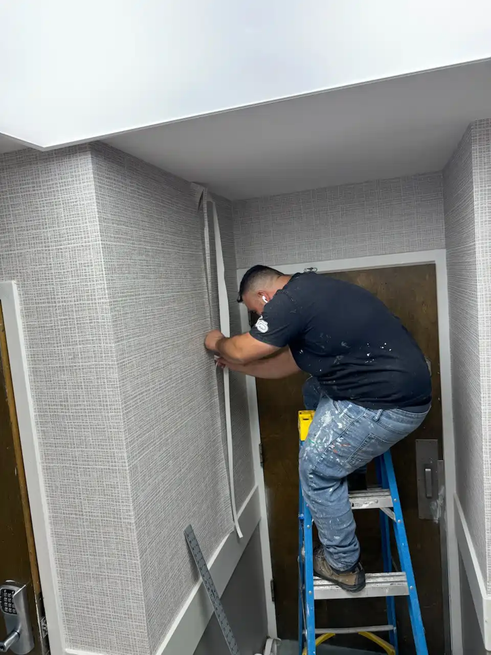 Surface preparation expert applying primer to wall